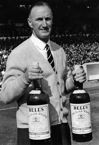 Harris John, Manager Sheffield United FC. holds two giant bottles of Bells whisky