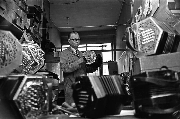 Harry Crabb seen here making concertinas in his workshop at Liverpool Street