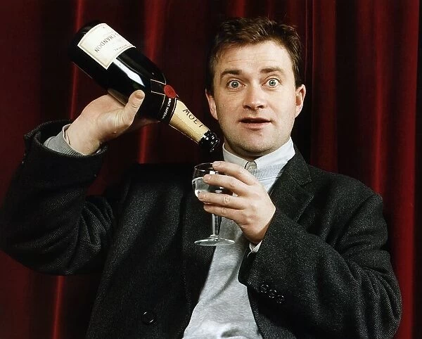 Harry Enfield Comedianenjoys a glass of bubbly at the opera Dbase