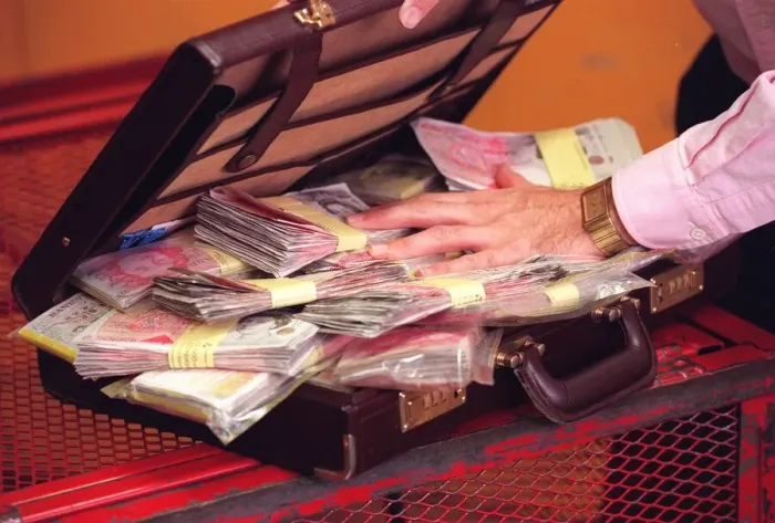 Framed Print : Harry Harris with a briefcase full of money Framed Print : Harry Harris with a briefcase full of money