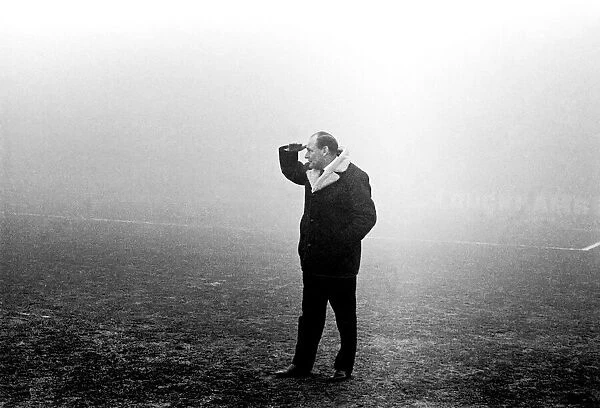 Harry Potts Manager of Burnley F. C. peers into the gloom at Manchester City ground today
