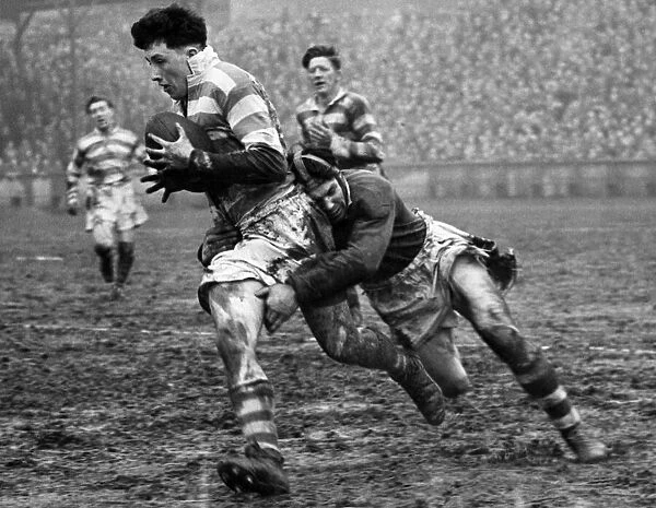 Harry Street of Wigan being tackled by G. Kibroy of Batley