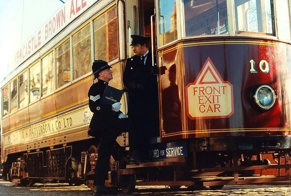 Harry Wynne dressed as a police segeant from 1919 boarding a tram at Beamish Museum
