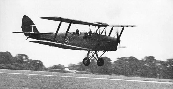 A de Havilland Tiger Moth landing on an airfiield. 02  /  07  /  1977