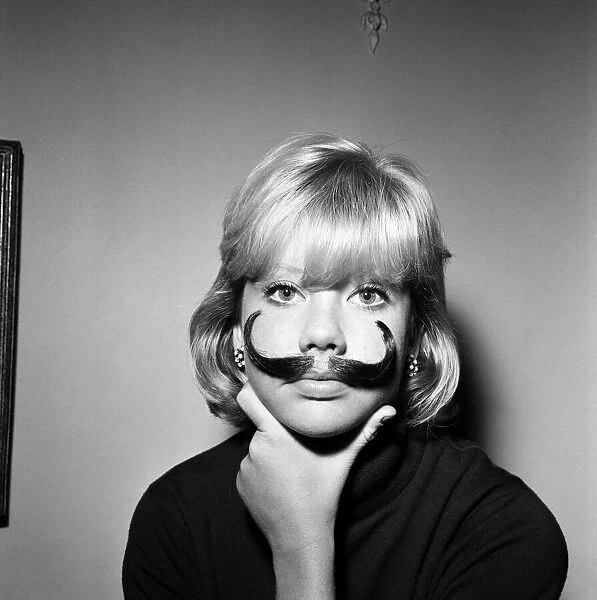 Hayley Mills wearing a genuine Dali imitation moustache, which can be bought for 12s. 6d