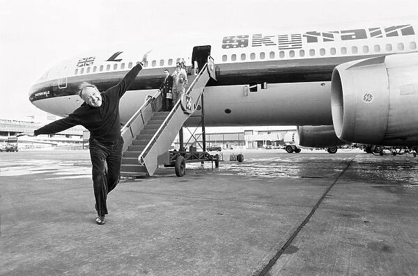 Head of Laker Airways Freddie Laker in jubilant mood on the runway at Gatwick airport