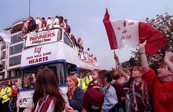 Heart of Midlothian footballers are cheered by fans as they celebrate with the Scottish
