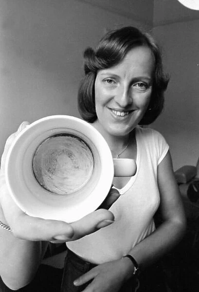 Heather Holmes with cup she claims to show face of Jesus Christ in residue 1980