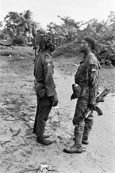 Two heavily armed Biafran soldiers seen here talking to each other during the Biafran