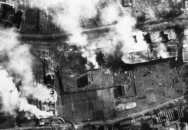 Heavy damage to Kassel after an R. A. F. raid. Pictured, five fires still burning among