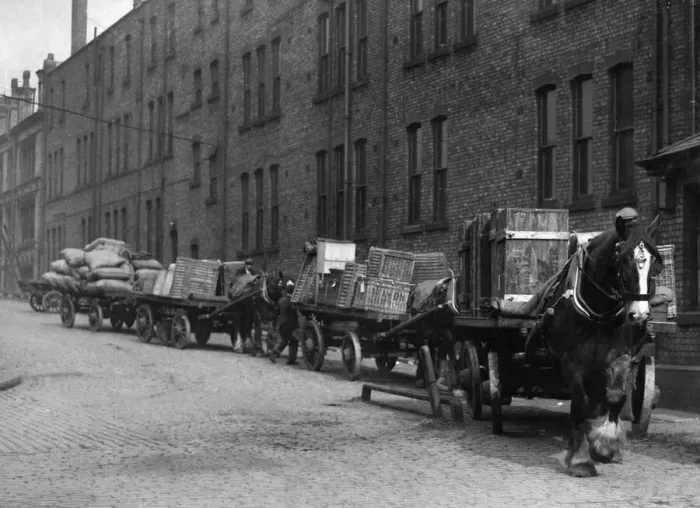 Framed Print : Heavy horses with their carts wait to offload their deliveries in this un-named Framed Print : Heavy horses with their carts wait to offload their deliveries in this un-named