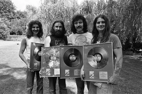 Heavy Metal group Black Sabbath pictured with the silver discs they received for