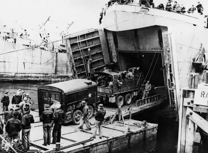 Framed Print : A heavy truck pulls a field kitchen up the bow ramp of an LST (Landing Ship Tank