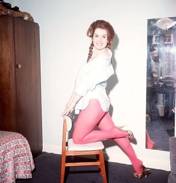 Heller Toren model actress 1964 knee on chair holding back pink tights white shirt