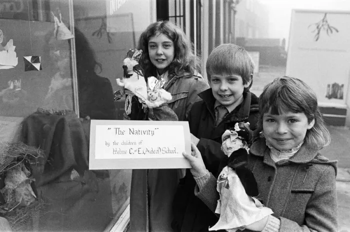 Framed Print : Helme Junior School pupils arranging their Nativity scene in the window of a Meltham Framed Print : Helme Junior School pupils arranging their Nativity scene in the window of a Meltham