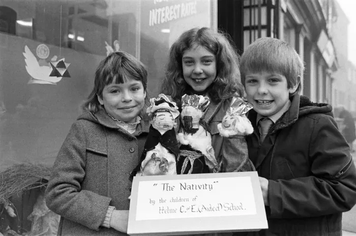 Framed Print : Helme Junior School pupils arranging their Nativity scene in the window of a Meltham Framed Print : Helme Junior School pupils arranging their Nativity scene in the window of a Meltham