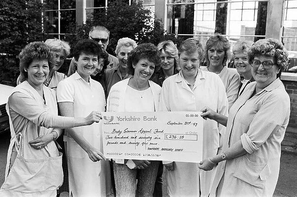 Helpful people with a large cheque... thats Rawthorpe High School