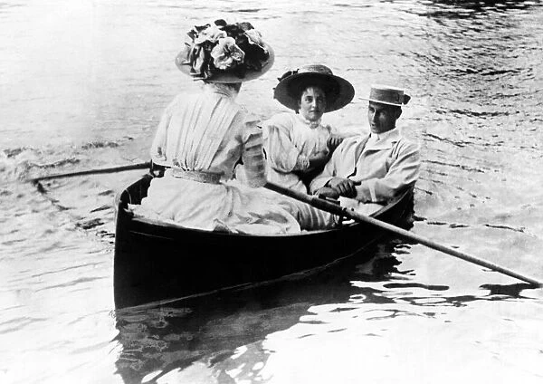 Henley Regatta. Man and two ladies boating on the river