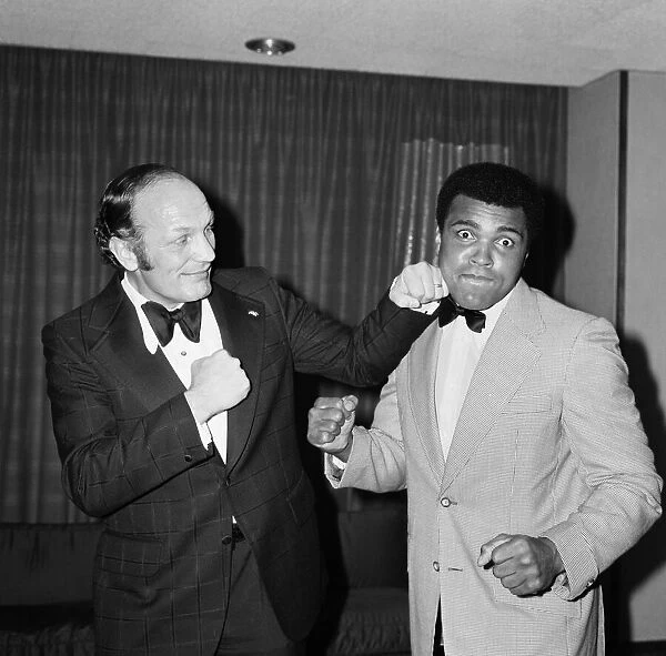 Henry Cooper fooling around with fellow boxer Muhammad Ali at a press conference in