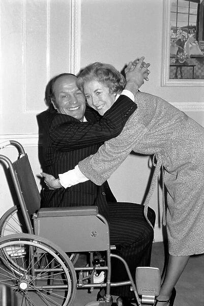 Henry Cooper is the patient and Dame 'Nurse'Vera Lynn helps him out