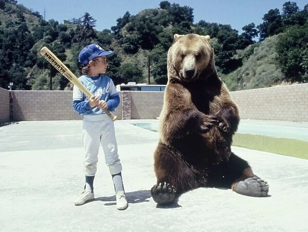Hercules the bear is learning about baseball from a young boy in Hollywood May 1983