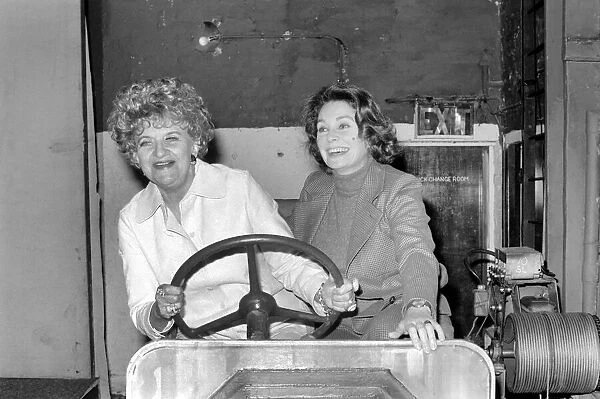 Hermione Gingold (L) and Jean Simmons (R) in a stage prop car at the Adelphi Theatre