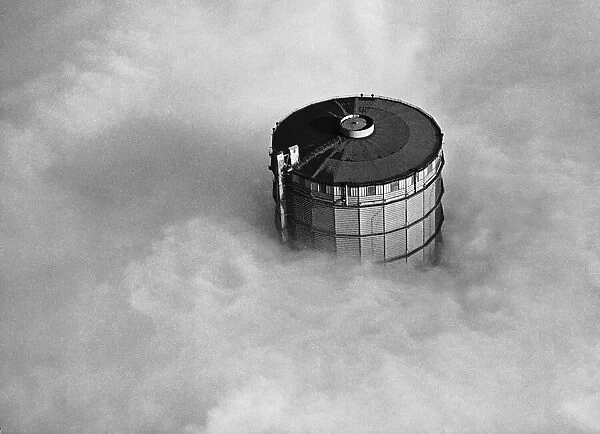 A High gas holder at Southall covered by fog in the Thames Valley