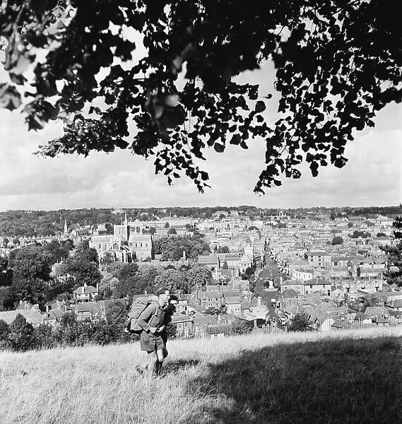 Hikers climb the hills that surround Winchester and its cathedral. September 1952 C4378