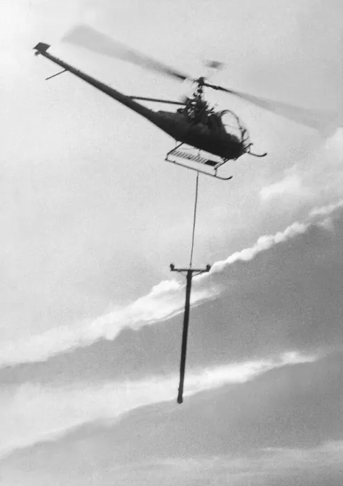 Framed Print : A Hiller 12E helicopter carries a telegraph pole across Grouse Moor at Kings Law Framed Print : A Hiller 12E helicopter carries a telegraph pole across Grouse Moor at Kings Law