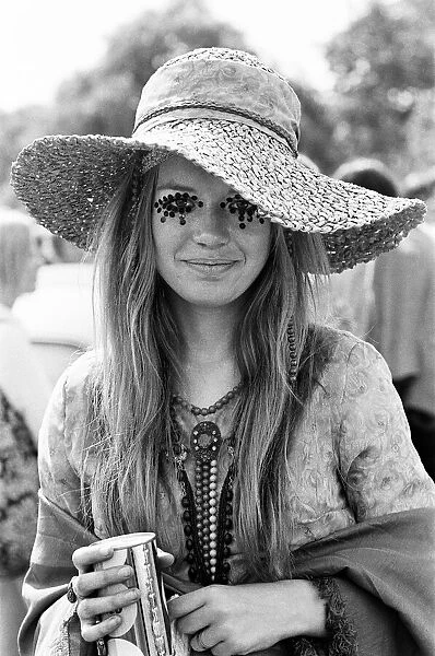 Hippie lady with large hat and eye make up at the free Rolling Stones concert in Hyde