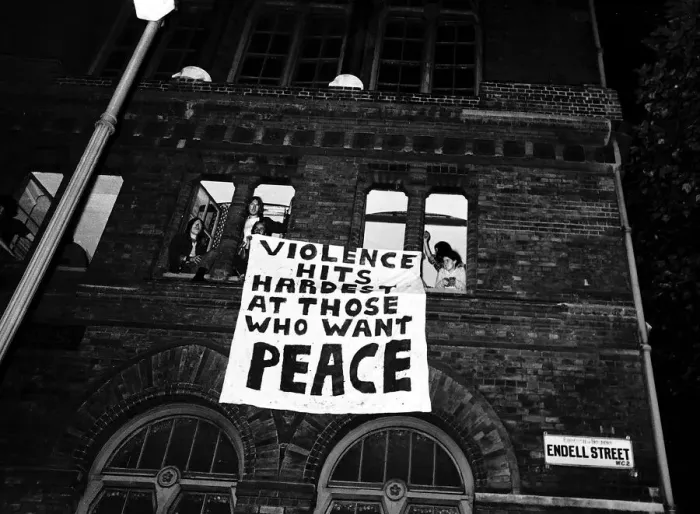 Framed Print : Hippies with banner hanging from window before police arrived to evict them from their Framed Print : Hippies with banner hanging from window before police arrived to evict them from their