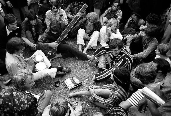 Hippies gather listening & playing music at Hyde Park 1967 during a peace demonstration