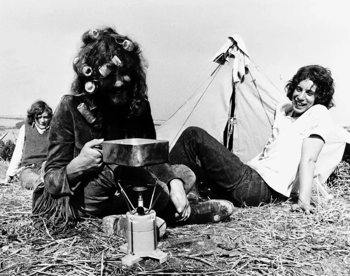 Framed Print : Hippies on Isle of Wight for pop festival cooking on camping stove in front of tent
