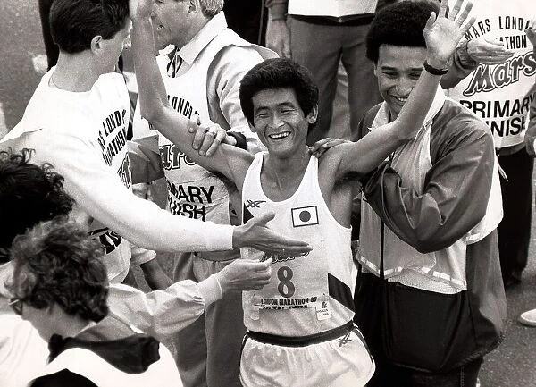 Hiromi Taniguchi holds his arms in the air to celebrate winning the 1987 London Marathon