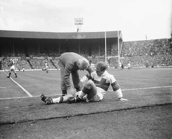 Hirst of Wakefield Trinity seen here gets treatment for a injury leg during the Rugby