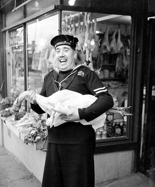 HM Submariner Bill Hayne enjoys collects the turkey for christmas dinner whilst on a