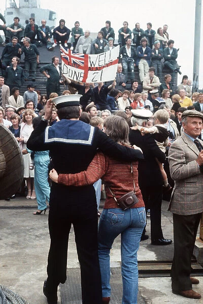 HMS Arrow Falklands War a sailor walks along arm in arm with his wife after arriving back