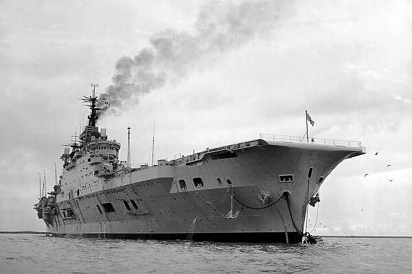 HMS Eagle gets up steam whilst at anchor in Plymouth sound. November 1951