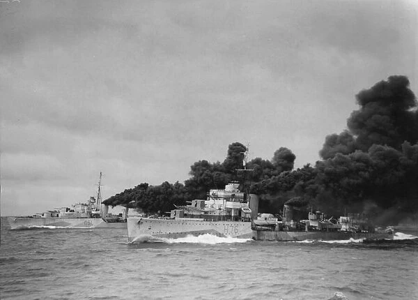 HMS Fury (in the foreground) and HMS Ashanti laying a smoke screen after a dummy torpedo
