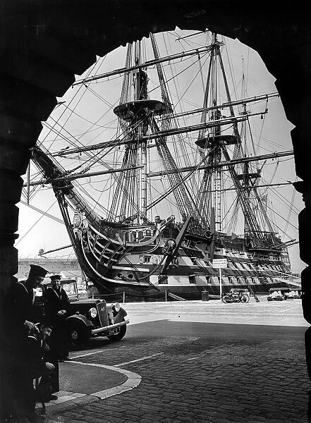 HMS Victory the flagship of the fleet framed in an arch in Portsmouth dockyard