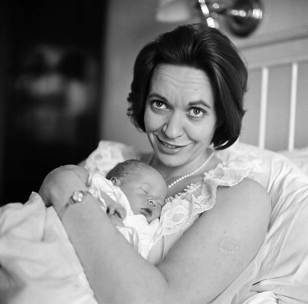 Holding her 12-hour old baby is stage and TV actress Lillias Walker