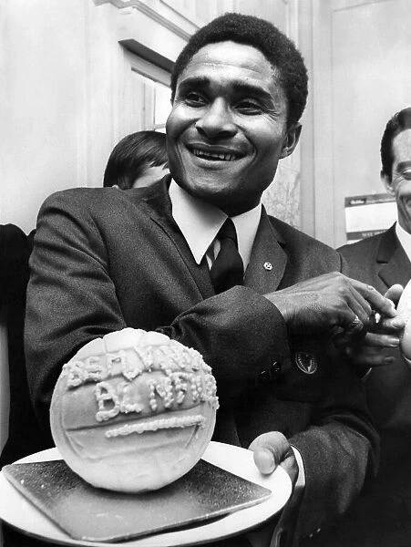 Holding a football made of ice-cream is Eusebio, at a London reception. May 1968 P009852