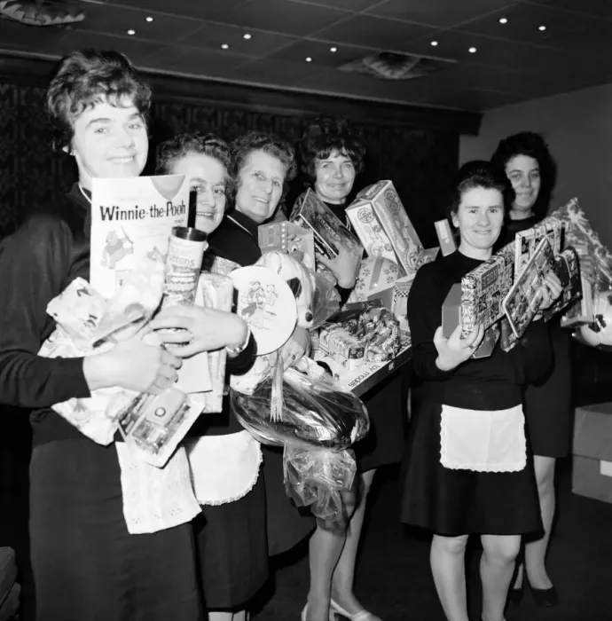 Framed Print : Holding presents they have bought with the rest of the banqueting staff at Skyway Airport