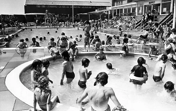 Holiday makers enjoy the Swimming and Paddling Pools at Trecco Bay, Porthcawl, Bridgend