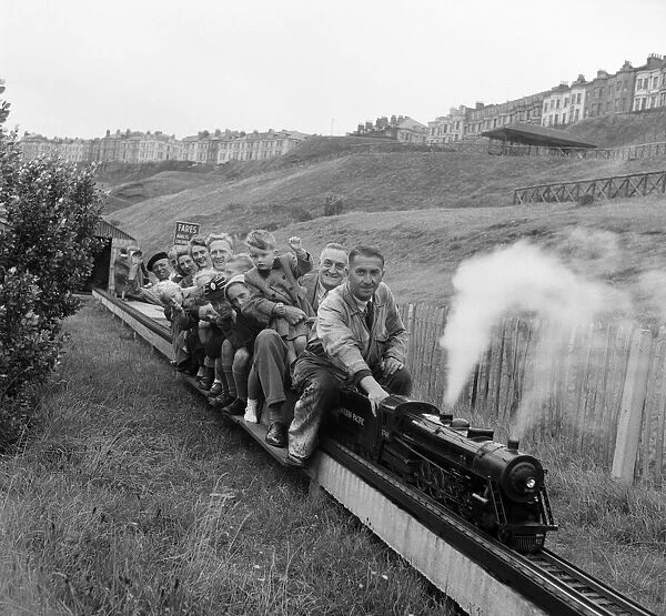 Holiday makers enjoying a ride on a miniature train. Scarborough, North Yorkshire