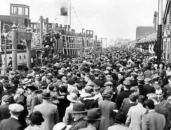 Holiday makers on the landing stage and ferry boats headed for New Brighton