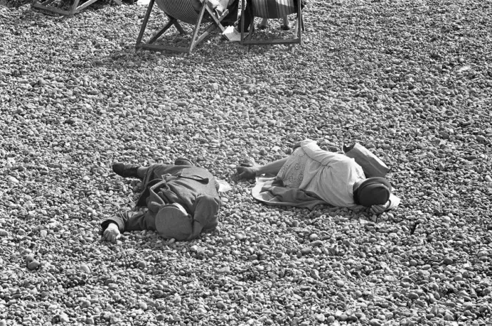 Framed Print : Holiday scenes at Brighton. Two elderly holidaymakers sleeping on the beach after
