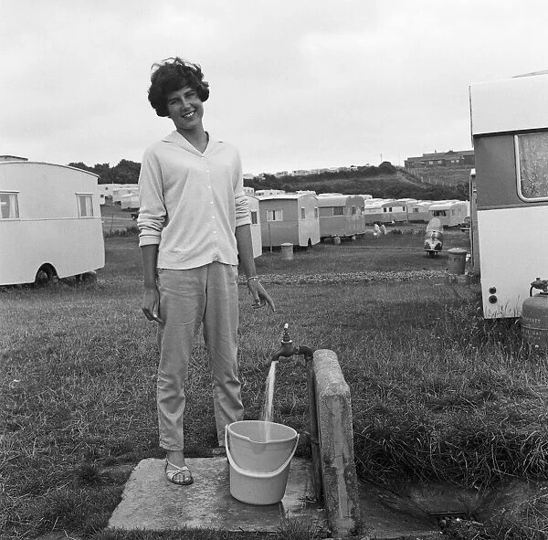 A holidaymaker collects water at Sandy Bay Caravan site, near Exmouth, Devon