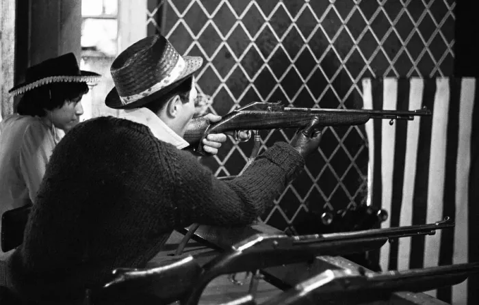Framed Print : Holidaymaker tries his luck on the rifle range at the end of Southend pier Framed Print : Holidaymaker tries his luck on the rifle range at the end of Southend pier