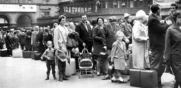 Holidaymakers and families queue for trains at Glasgow Central Station, Glasgow, Scotland